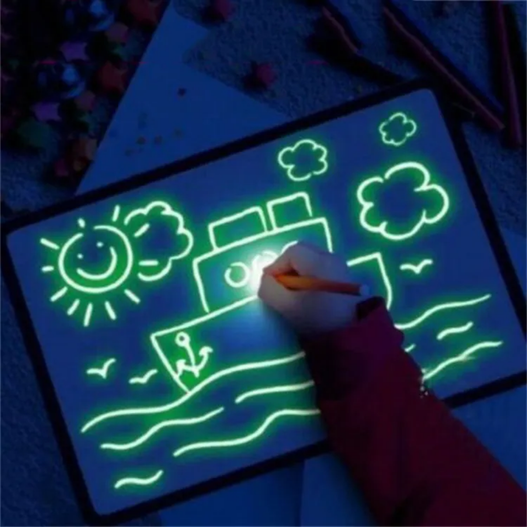 Glowing drawing tablet with a child's hand using a pen in a dark setting