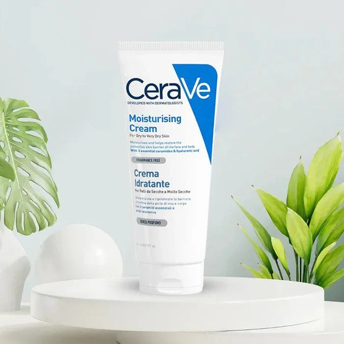 CeraVe moisturizing cream tube on a white platform with green plants in the background